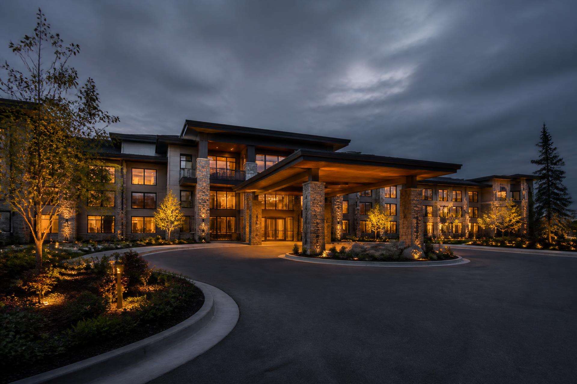 Senior living community exterior at dusk
